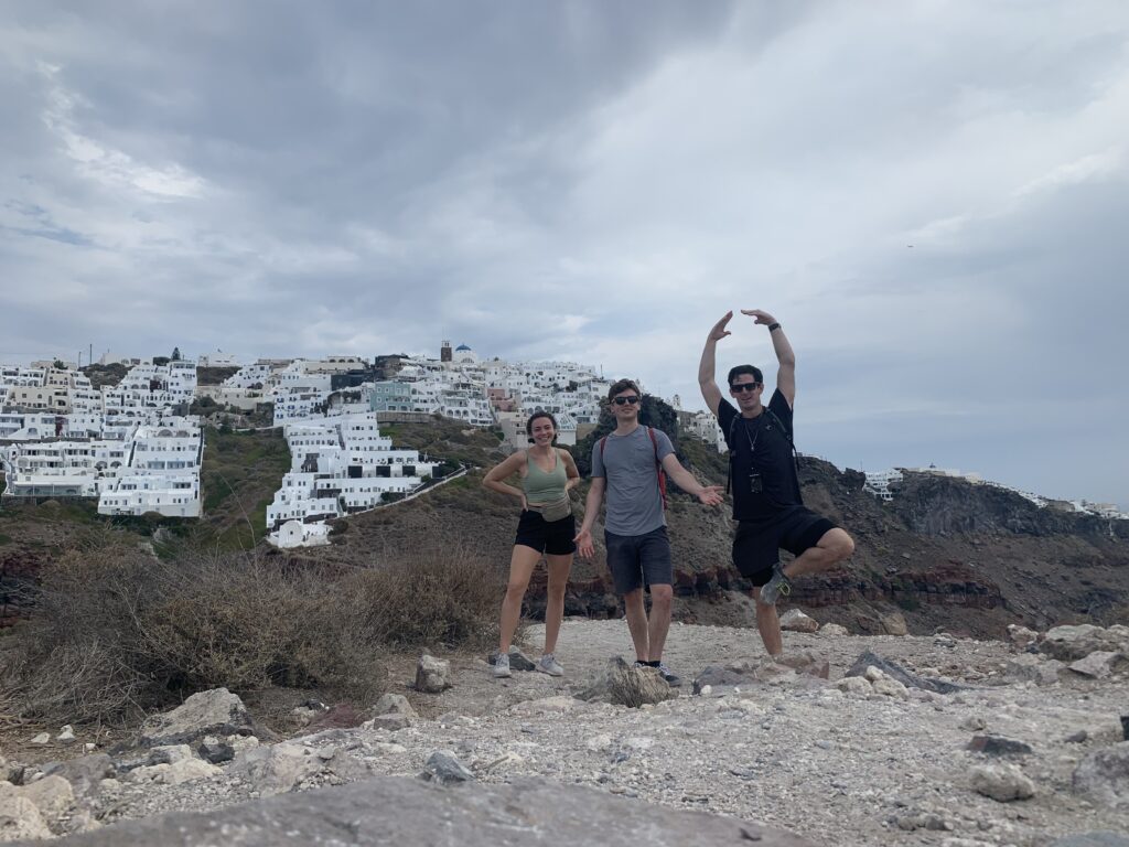 Alexa, Daniel, and Justin pose at the peak of their hike up the Castle of Skaros in Santorini, Greece.