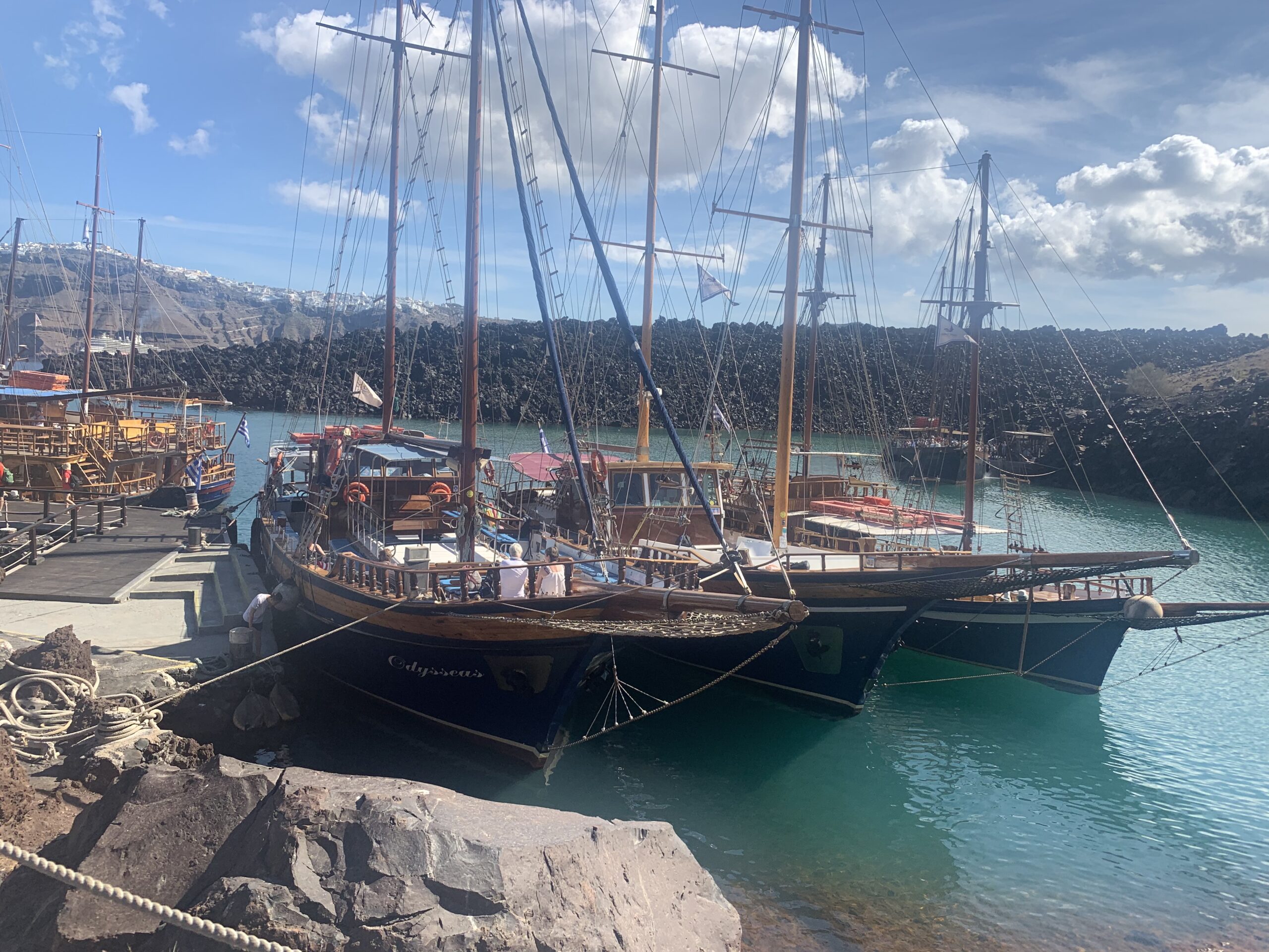 Sailboats docked at bay at the volcano of Santorini, Greece