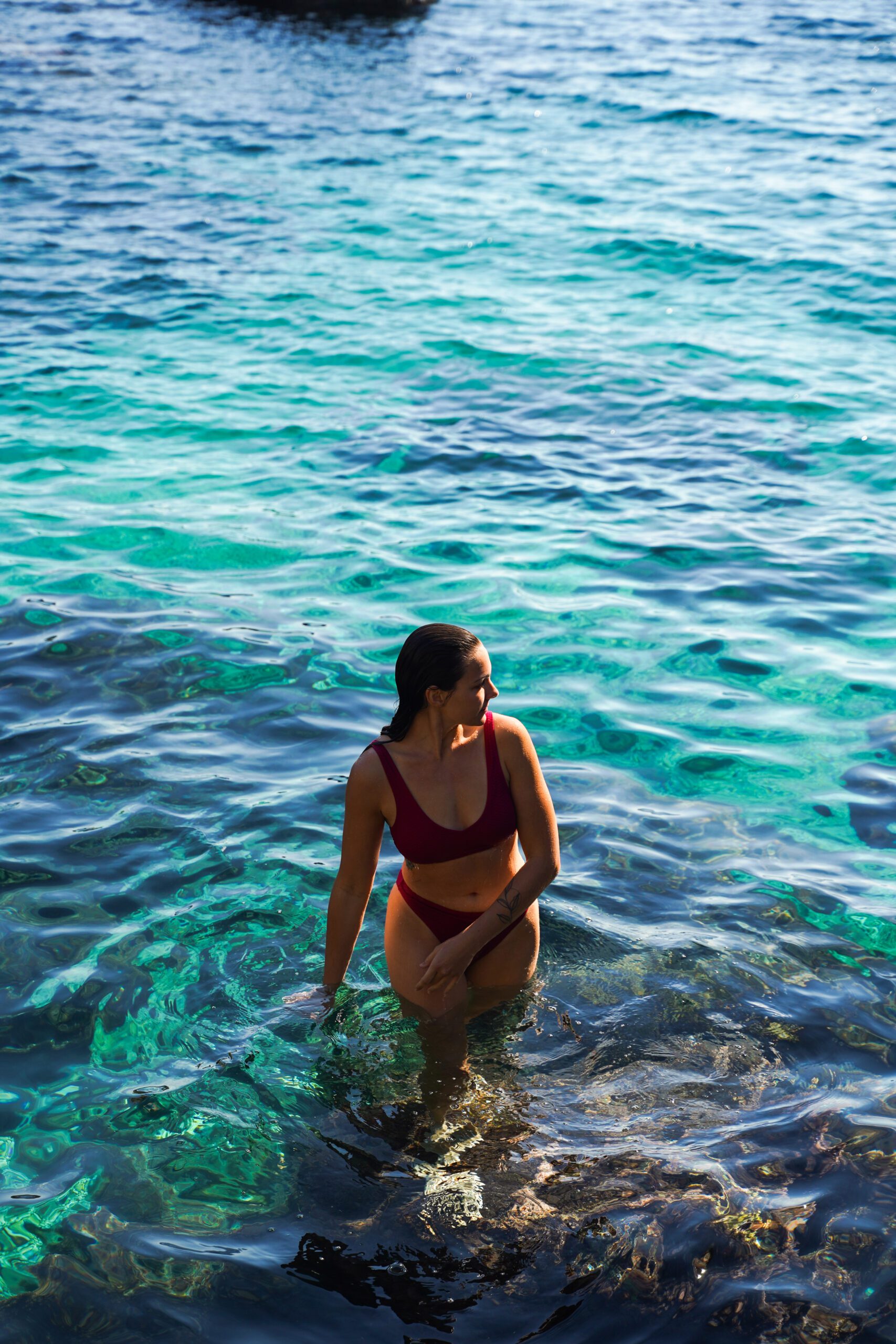 Alexa emerges from the teal-blue water in Corfu, Greece