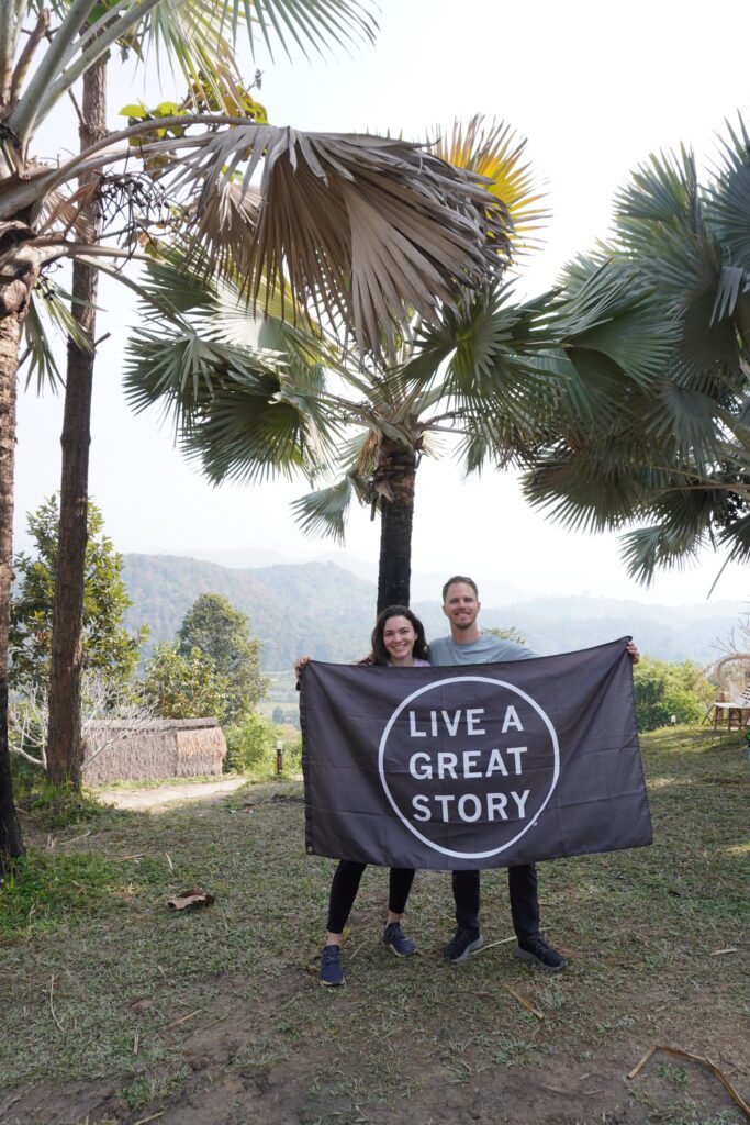 Two people holding a live a story banner.