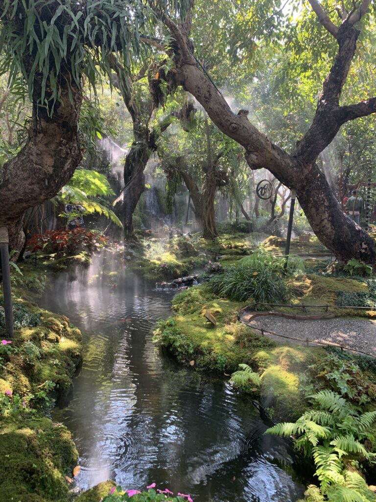 A stream flowing through a vibrant garden.