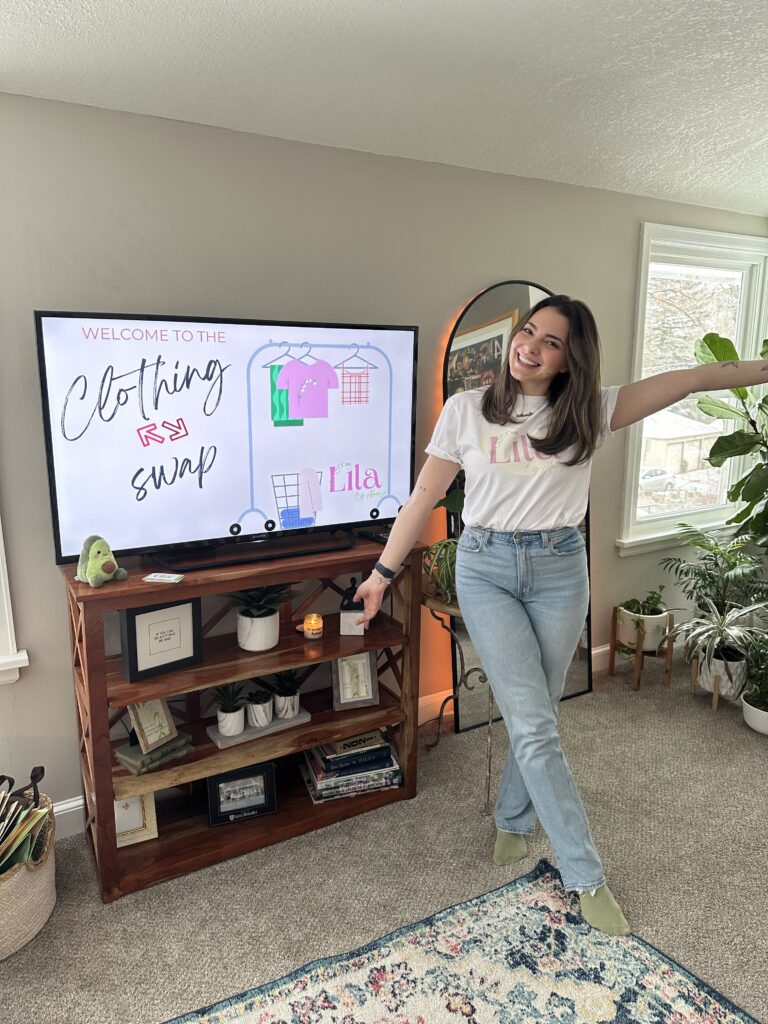 A woman standing in front of a tv in a living room.